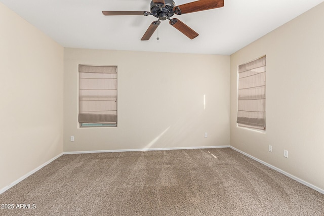 spare room with built in shelves, ceiling fan, and carpet floors