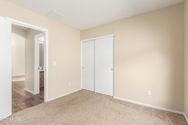 unfurnished bedroom with carpet and a closet