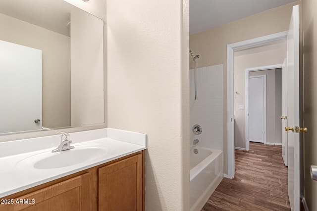 bathroom featuring vanity, hardwood / wood-style floors, and shower / tub combination