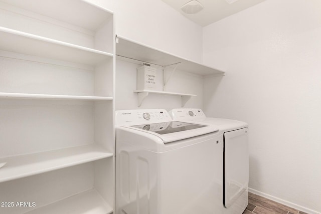 laundry area featuring wood-type flooring and washing machine and clothes dryer