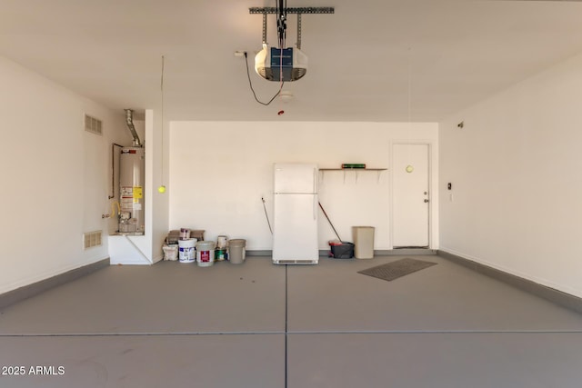 garage with a garage door opener, gas water heater, and white refrigerator