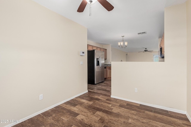 spare room with dark hardwood / wood-style flooring and ceiling fan with notable chandelier