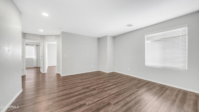 2668 N 73rd Gln, Phoenix, AZ 85035 - unfurnished room featuring dark wood-type flooring, baseboards, and recessed lighting