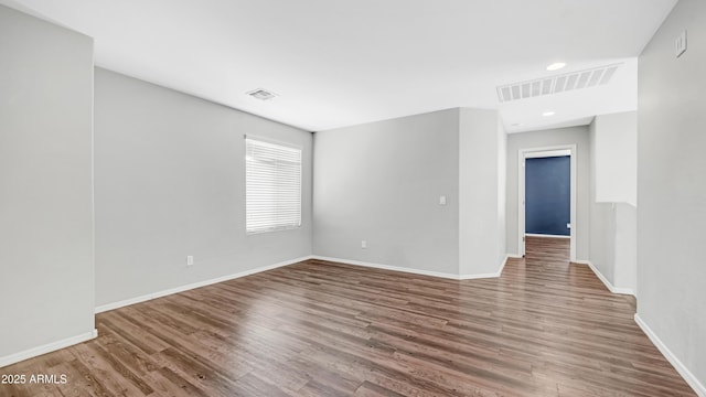 2668 N 73rd Gln, Phoenix, AZ 85035 - empty room with wood finished floors, baseboards, and recessed lighting