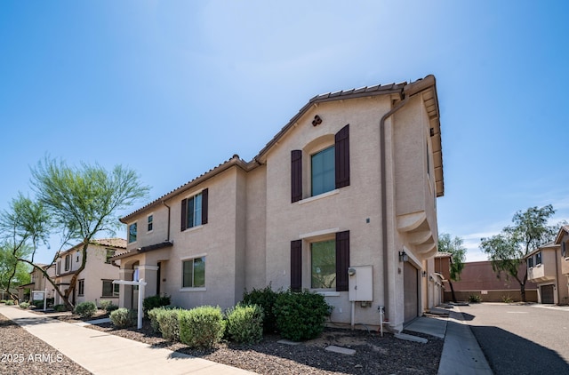 2668 N 73rd Gln, Phoenix, AZ 85035 - view of front facade featuring stucco siding, a tiled roof, and a residential view