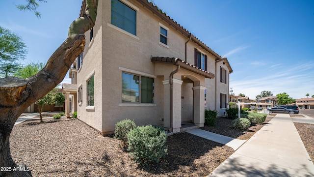 2668 N 73rd Gln, Phoenix, AZ 85035 - view of side of home featuring stucco siding and a tiled roof