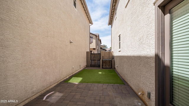 2668 N 73rd Gln, Phoenix, AZ 85035 - view of side of property with stucco siding, a gate, and a patio