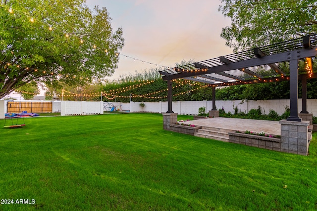 yard at dusk featuring a patio area, a pergola, and a trampoline