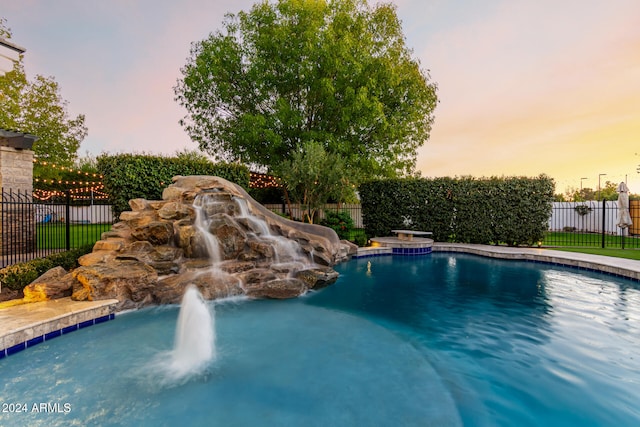 view of pool at dusk