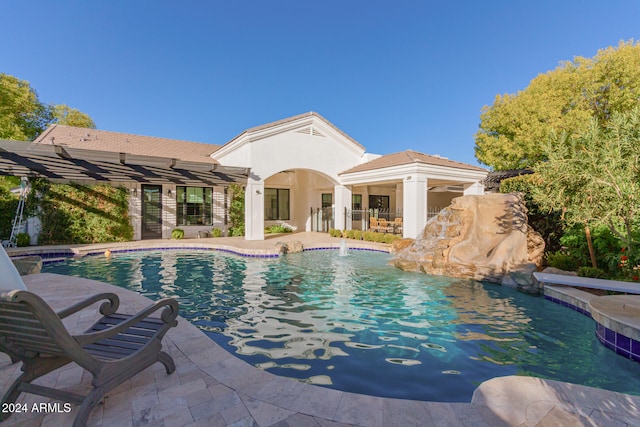 view of pool with pool water feature and a patio area