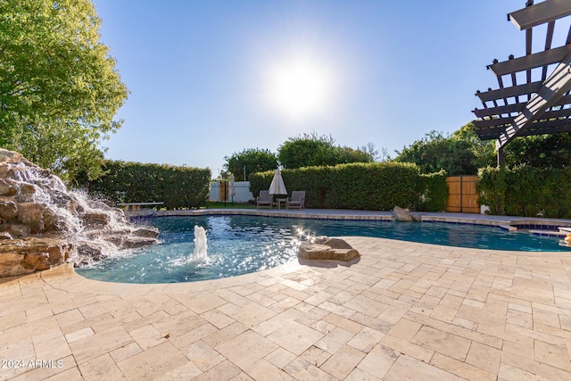 view of pool with a pergola and pool water feature