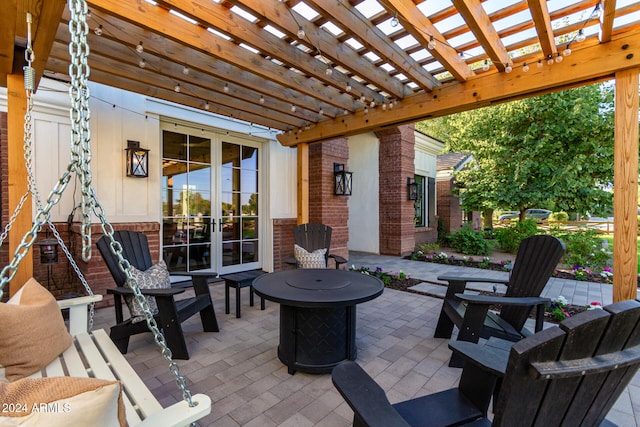 view of patio featuring a pergola, french doors, and a fire pit