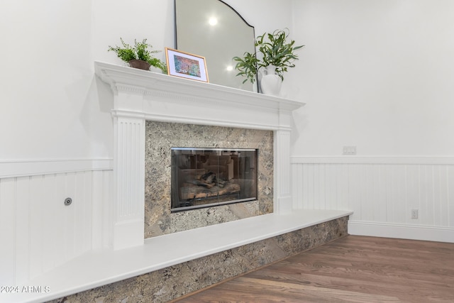 interior details featuring hardwood / wood-style floors and a high end fireplace