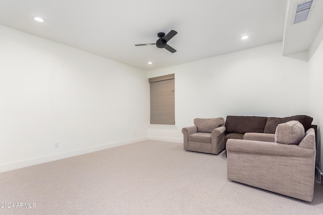 carpeted living room with ceiling fan