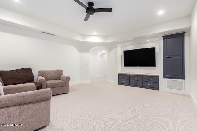 carpeted living room with ceiling fan