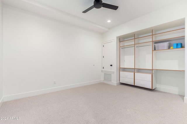 unfurnished bedroom featuring ceiling fan, light carpet, and a closet