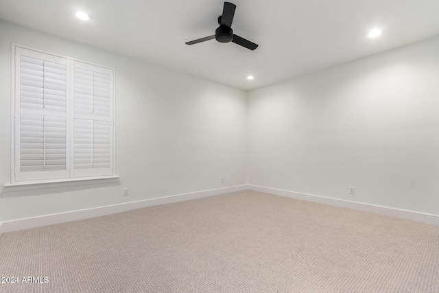 empty room with light carpet and ceiling fan