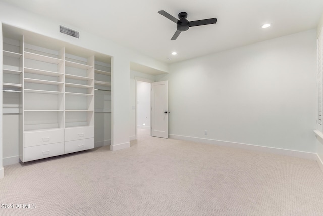 unfurnished bedroom with light colored carpet and ceiling fan