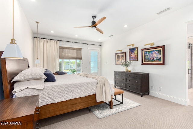 bedroom featuring access to outside, light carpet, and ceiling fan