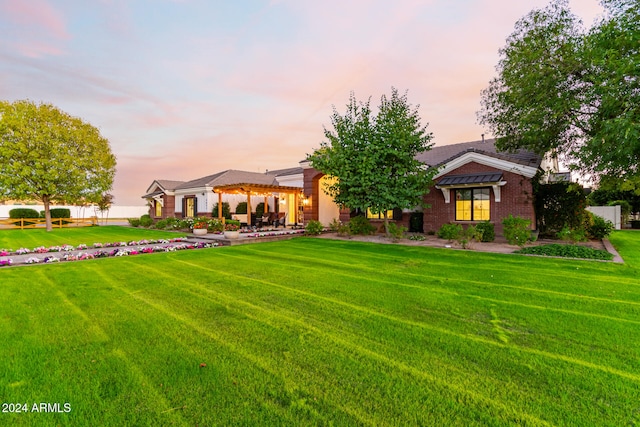 view of front of property with a yard