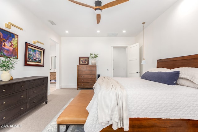 bedroom with light carpet, ceiling fan, and ensuite bathroom