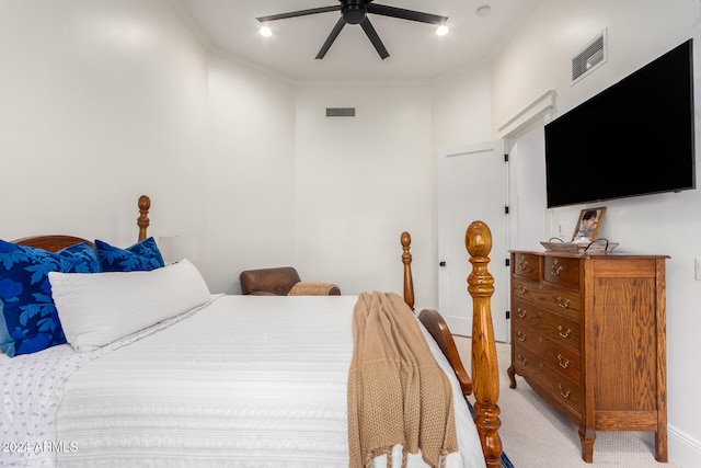 carpeted bedroom featuring ceiling fan and crown molding