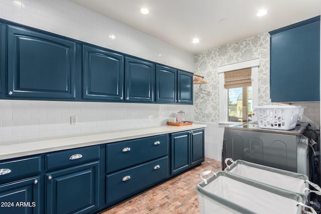 kitchen featuring washer / clothes dryer and blue cabinetry