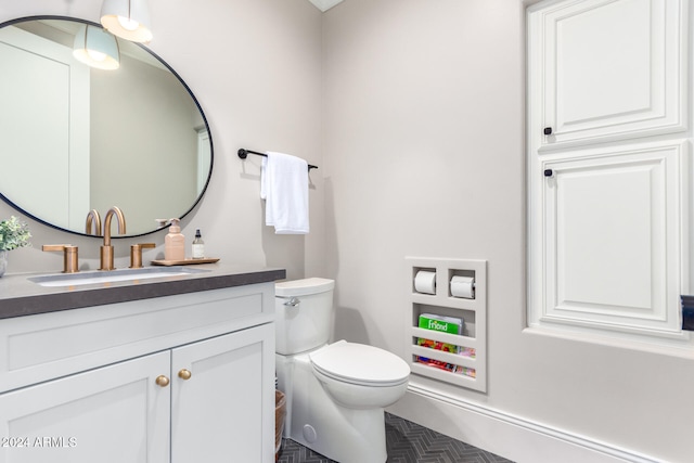 bathroom with toilet and vanity