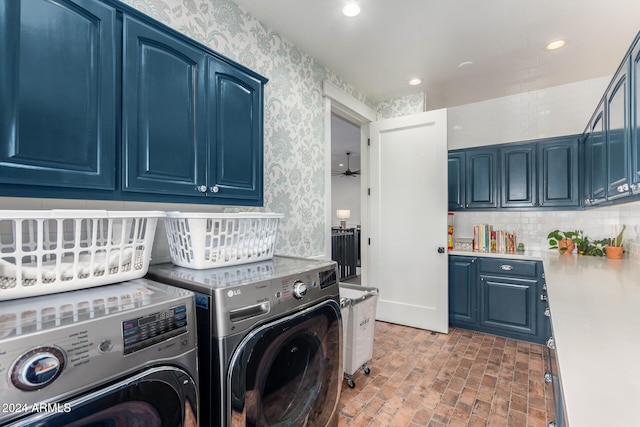 clothes washing area featuring washing machine and dryer and cabinets