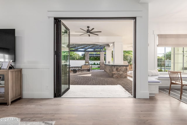 doorway featuring hardwood / wood-style floors and ceiling fan