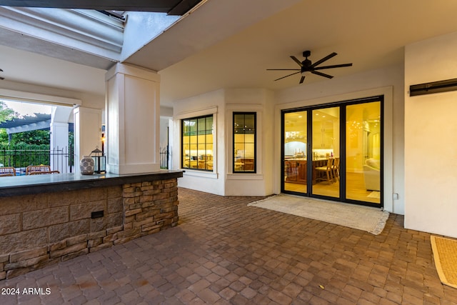 view of patio / terrace featuring a bar and ceiling fan