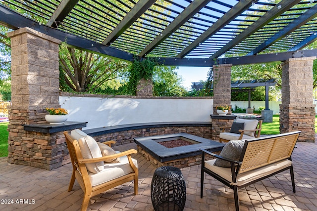 view of patio with a pergola and a fire pit