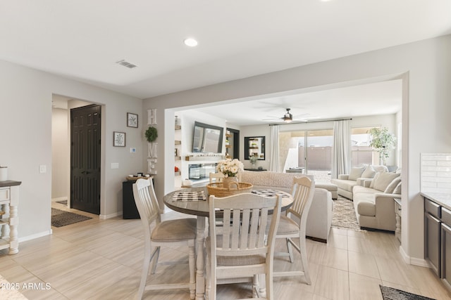 dining space with ceiling fan and light tile patterned flooring