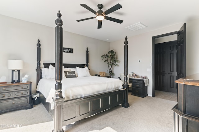 carpeted bedroom featuring ceiling fan and a closet