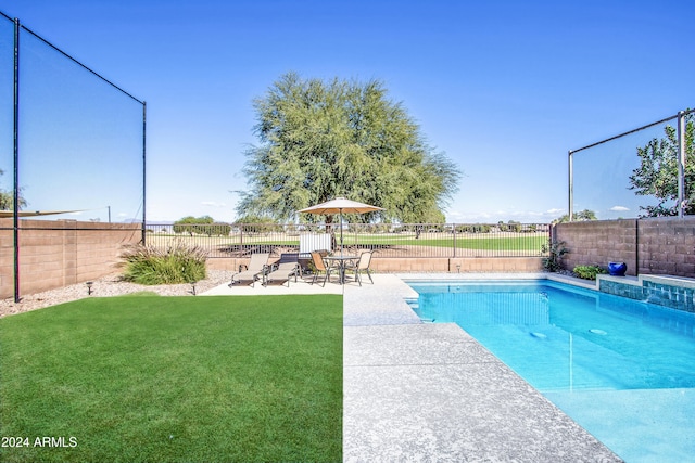 view of pool featuring a patio area and a yard