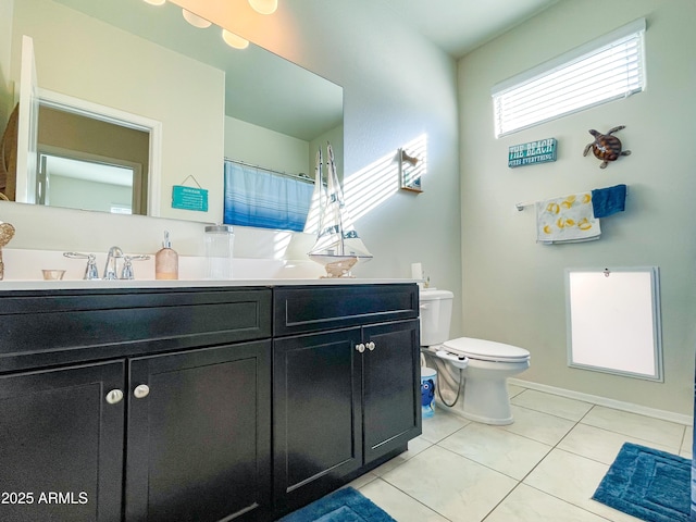 bathroom featuring toilet, tile patterned floors, and vanity