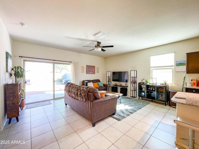 living room with ceiling fan and light tile patterned floors