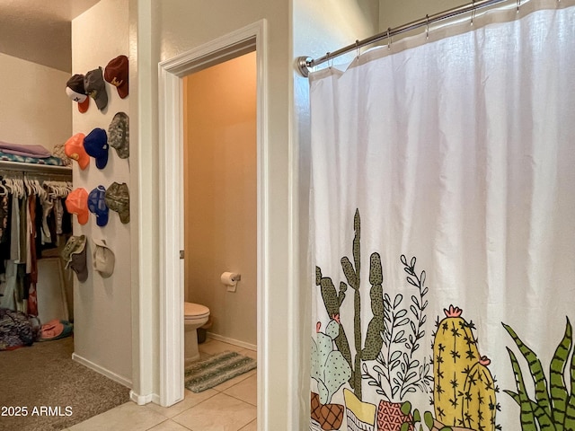 bathroom with toilet and tile patterned floors