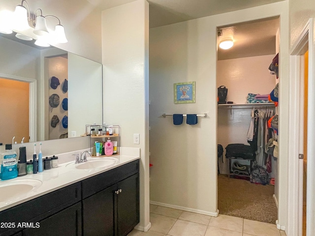 bathroom with tile patterned flooring, an inviting chandelier, and vanity