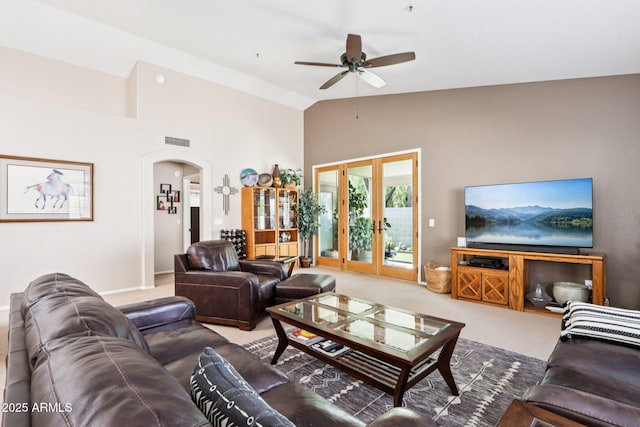 11861 E Becker Ln, Scottsdale, AZ 85259 - living room with arched walkways, ceiling fan, carpet, and high vaulted ceiling