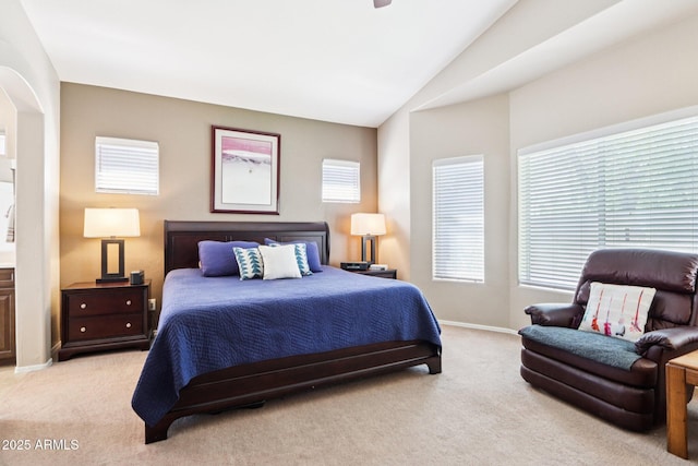 11861 E Becker Ln, Scottsdale, AZ 85259 - bedroom with light carpet, multiple windows, vaulted ceiling, and arched walkways
