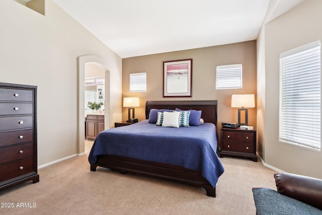 11861 E Becker Ln, Scottsdale, AZ 85259 - bedroom featuring light carpet, arched walkways, and multiple windows