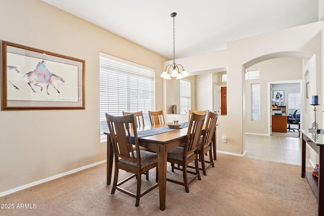 11861 E Becker Ln, Scottsdale, AZ 85259 - dining area with arched walkways, light colored carpet, and a chandelier
