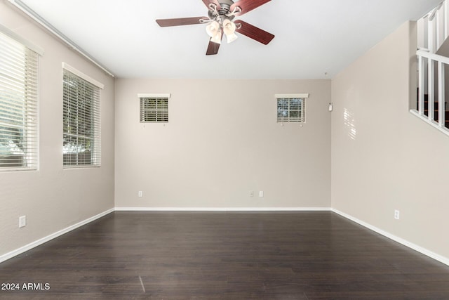 empty room featuring ceiling fan and dark wood-type flooring