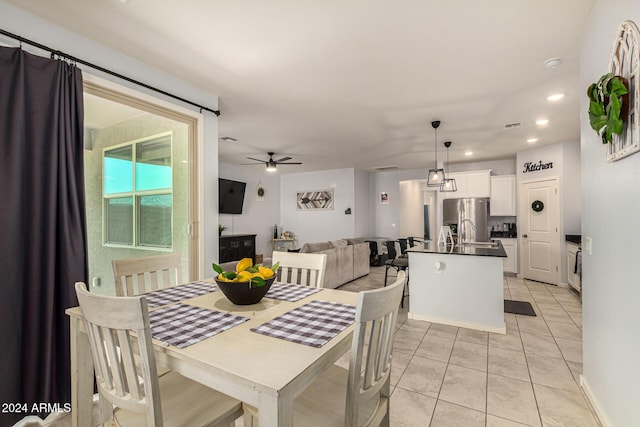 tiled dining area with ceiling fan