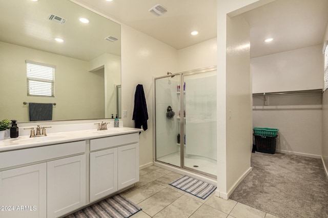 bathroom with tile patterned flooring, vanity, and an enclosed shower