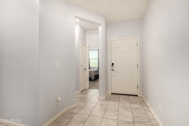 hallway featuring light tile patterned floors