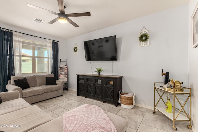 living room featuring ceiling fan and light tile patterned floors