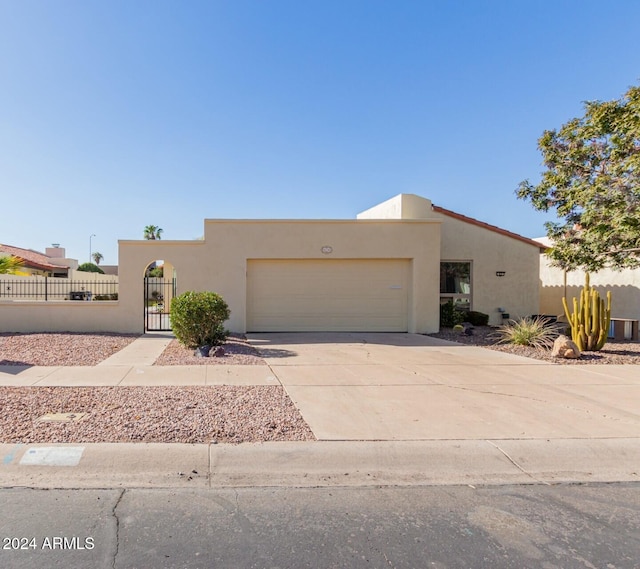 pueblo-style house featuring a garage