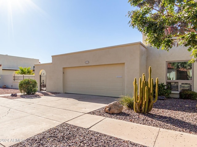 pueblo-style house with a garage